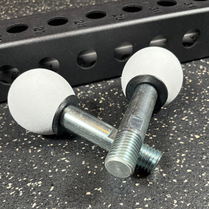 Two white spherical climbing holds for squat rack attachments and crossmember