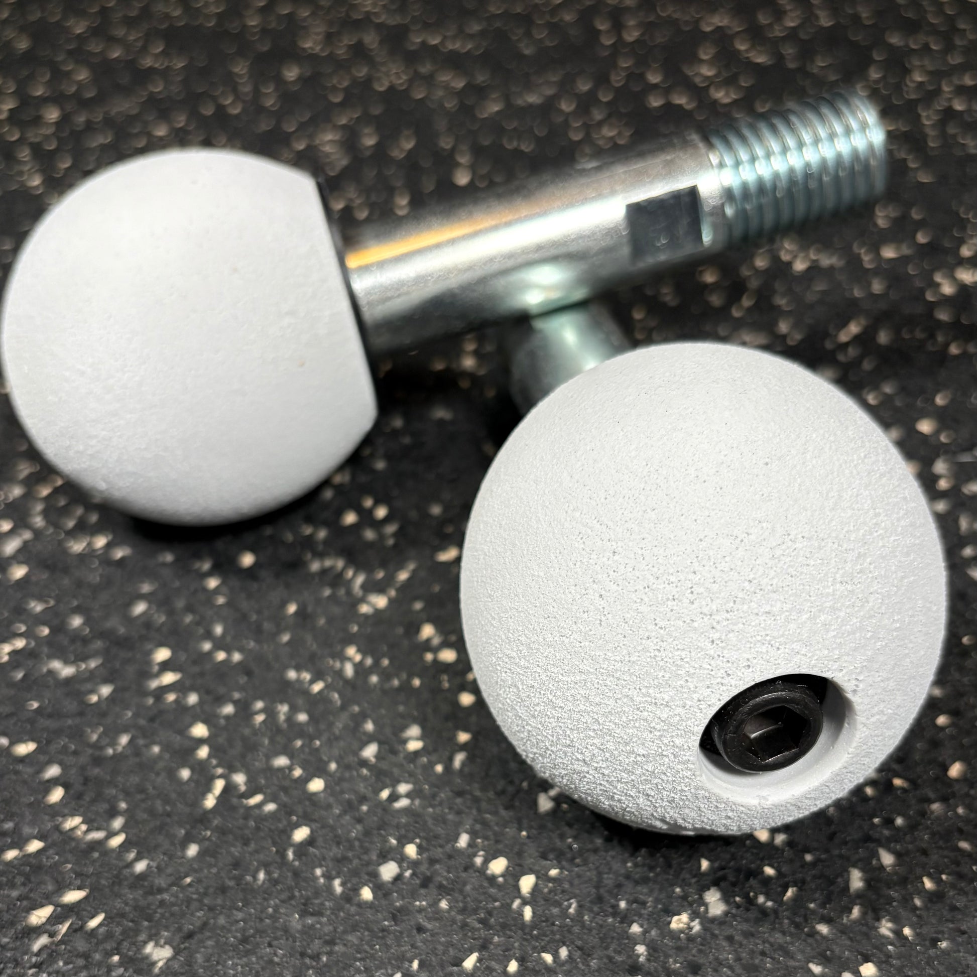 Two Kodo white spherical climbing holds for gym equipment squat rack attachments and crossmember