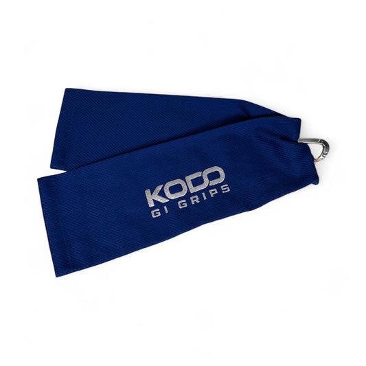 Blue Kodo Gi Grip with embroidered logo, featuring a custom aluminum carabiner attached to it used for martial arts such as BJJ and Judo and Grip Strength. These are premium Jiu Jitsu Grip trainers and Judo Grip Trainers. 